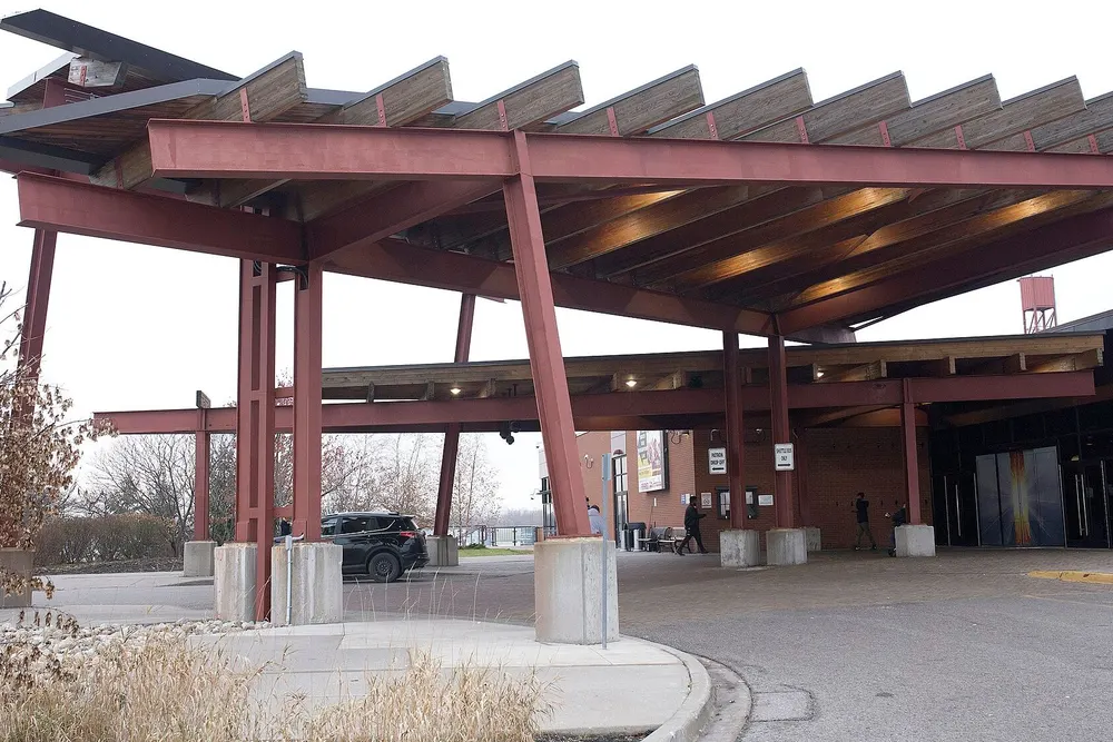 Casino Ajax: the timber-and-steel entrance canopy over the drop-off loop in late autumn