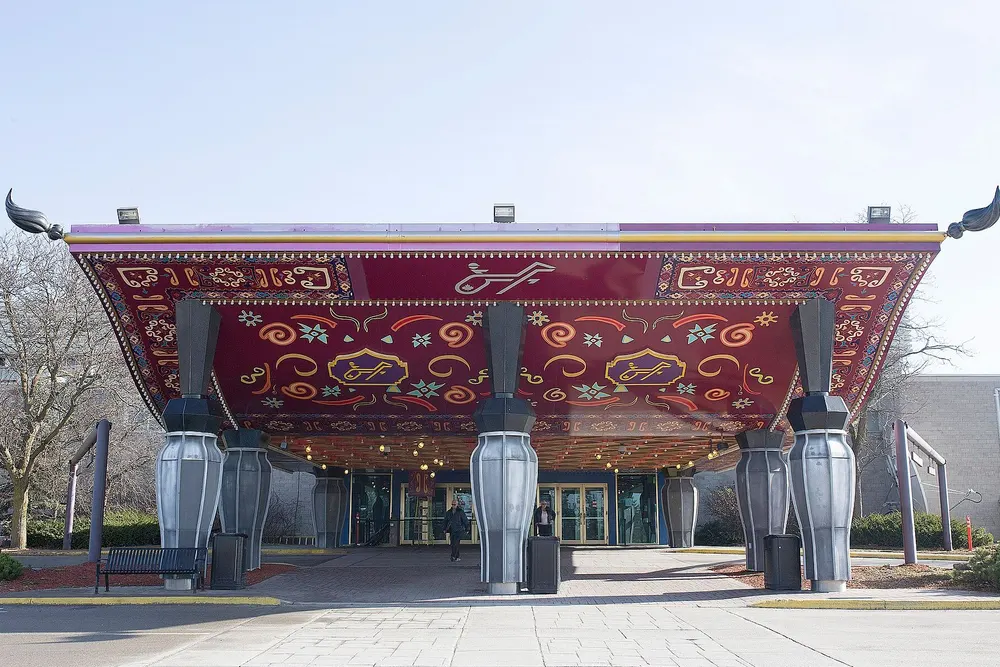 The ornate red entrance canopy of Flamboro Downs, home of Elements Casino Flamboro, on silver vase-shaped columns